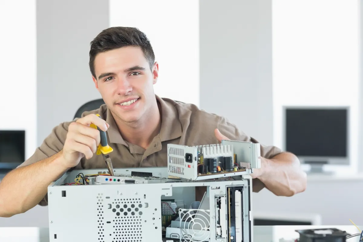 IT technician repairing a desktop computer